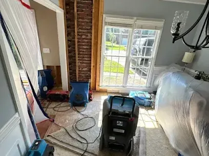 Plastic containment sheeting and drying equipment set up in a family room