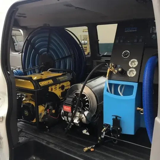 A truck-mounted extraction unit with its hose reel, loaded for a water call